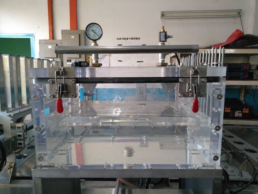 Pure Automation - An automated leak testing machine on a conveyor line, inspecting food packaging with digital sensors and status indicators.